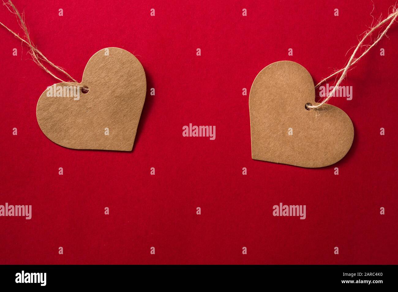 Brown heart-shaped label on red background Stock Photo