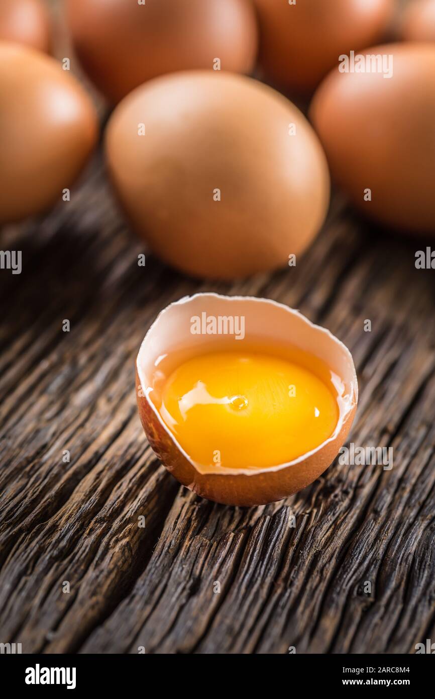 Fresh raw eggs on rustic wooden table Stock Photo