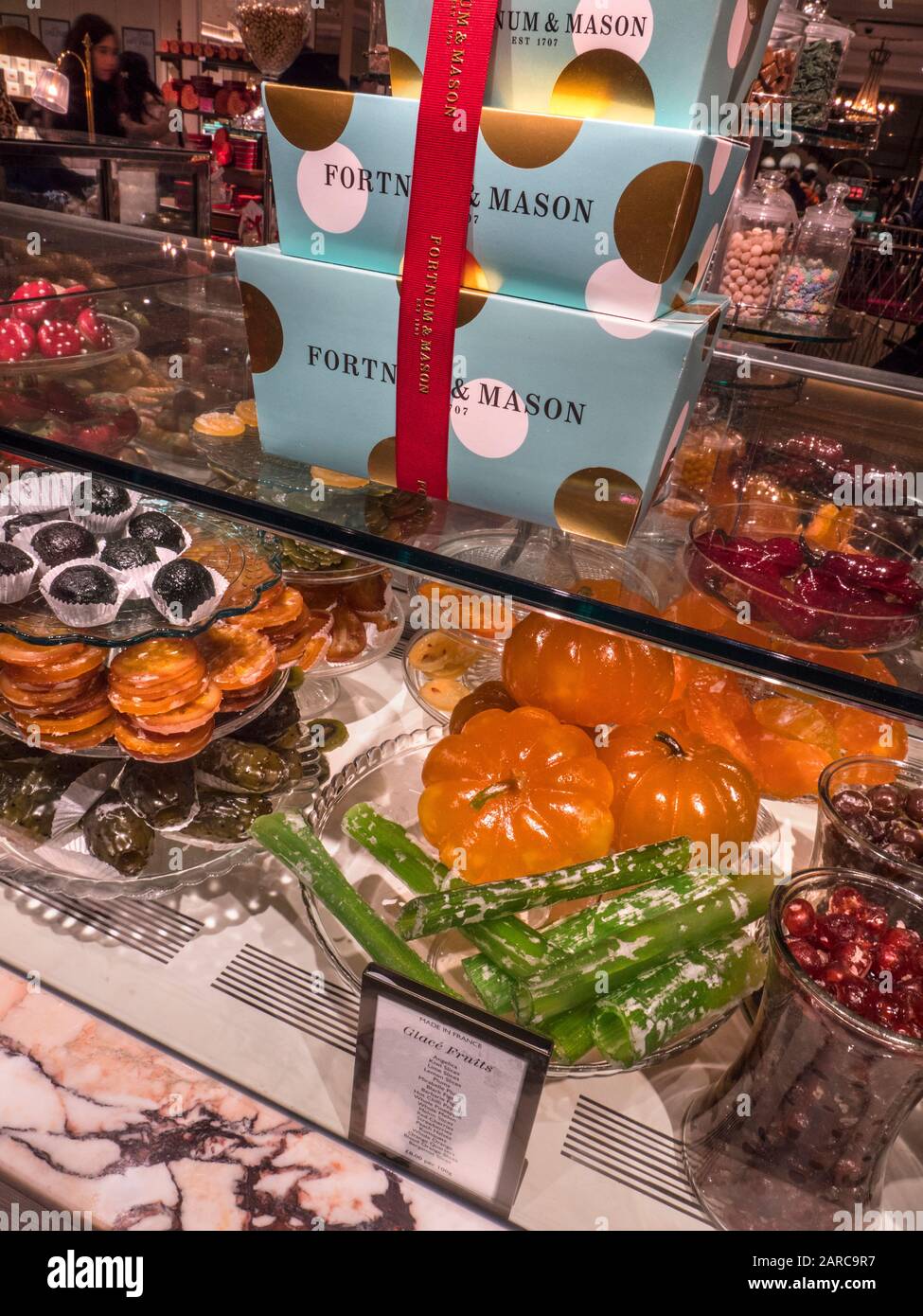 Fortnum & Mason Food Hall with luxury display of hand made glacé fruits selection such as Angelica, Kiwi slices , Black figs, Lemon slices, Peach halves, Kumquats, Fortnum & Mason Food Hall Piccadilly St. James's, London W1A 1ER Stock Photo