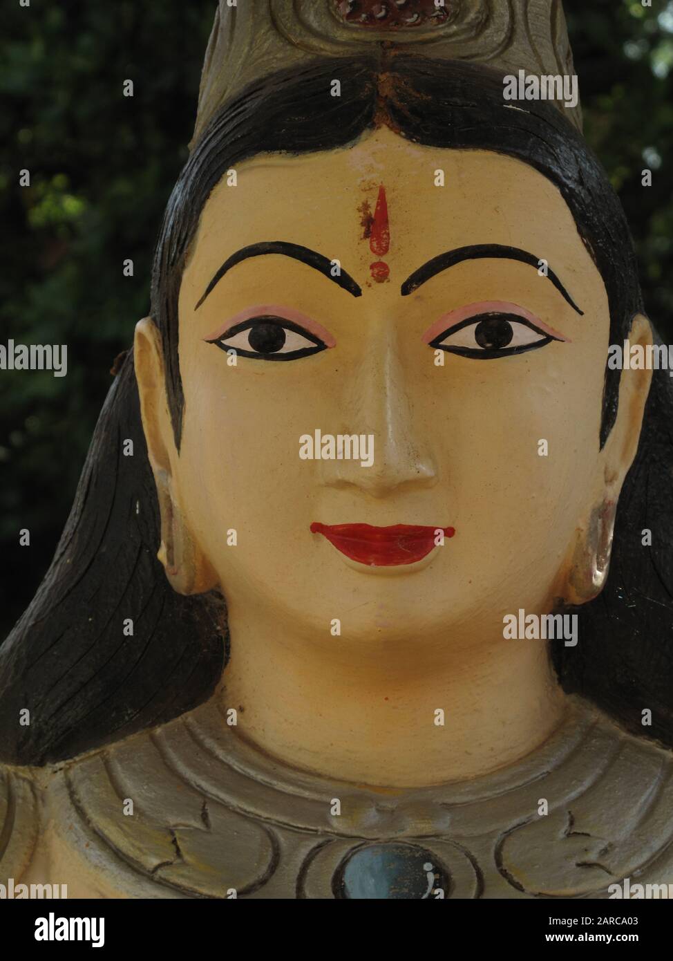 Vertical shot of a Hindu god statue with a blurred background Stock