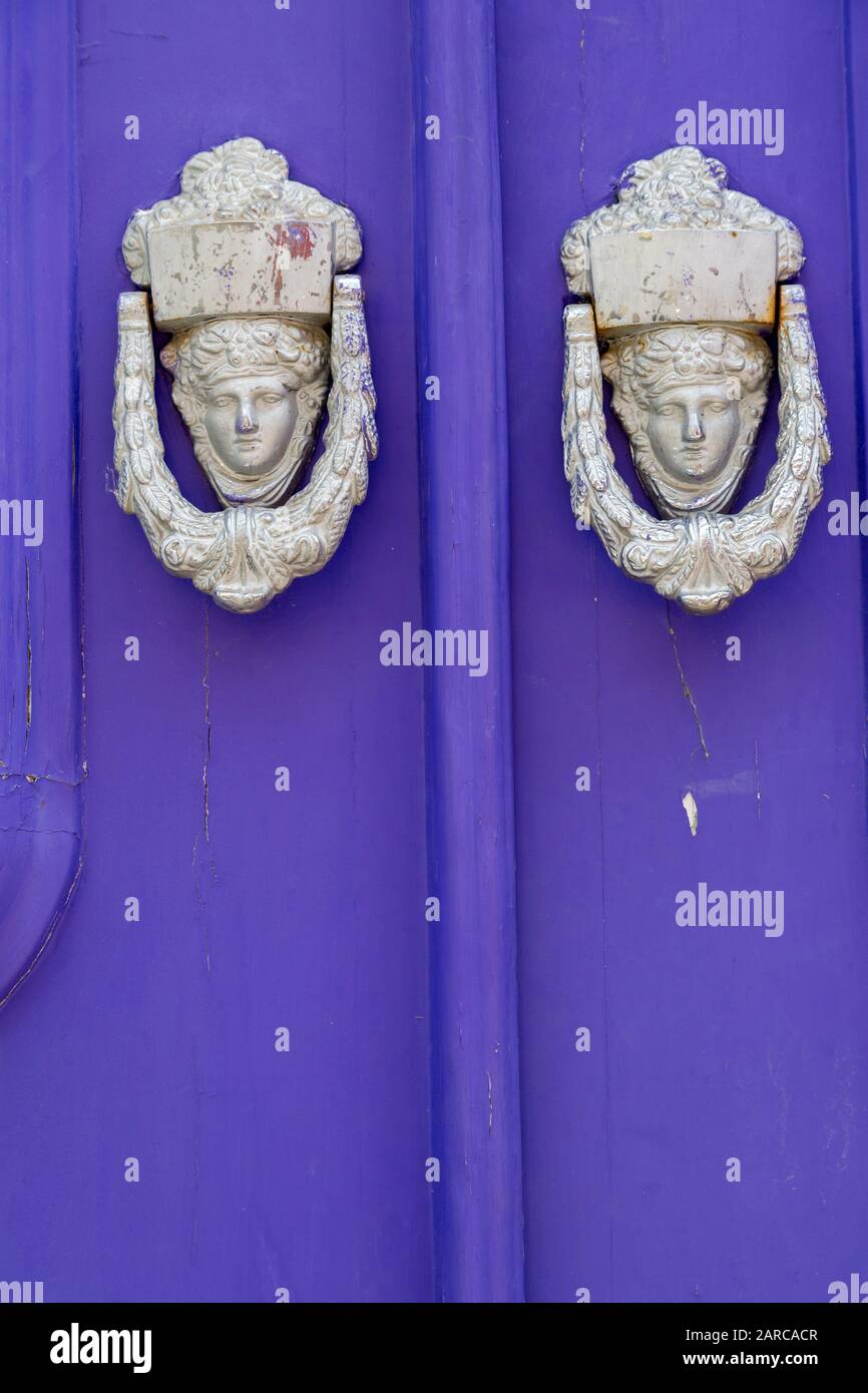 Faces in door knockers, Estoi, Algarve, Portugal Stock Photo