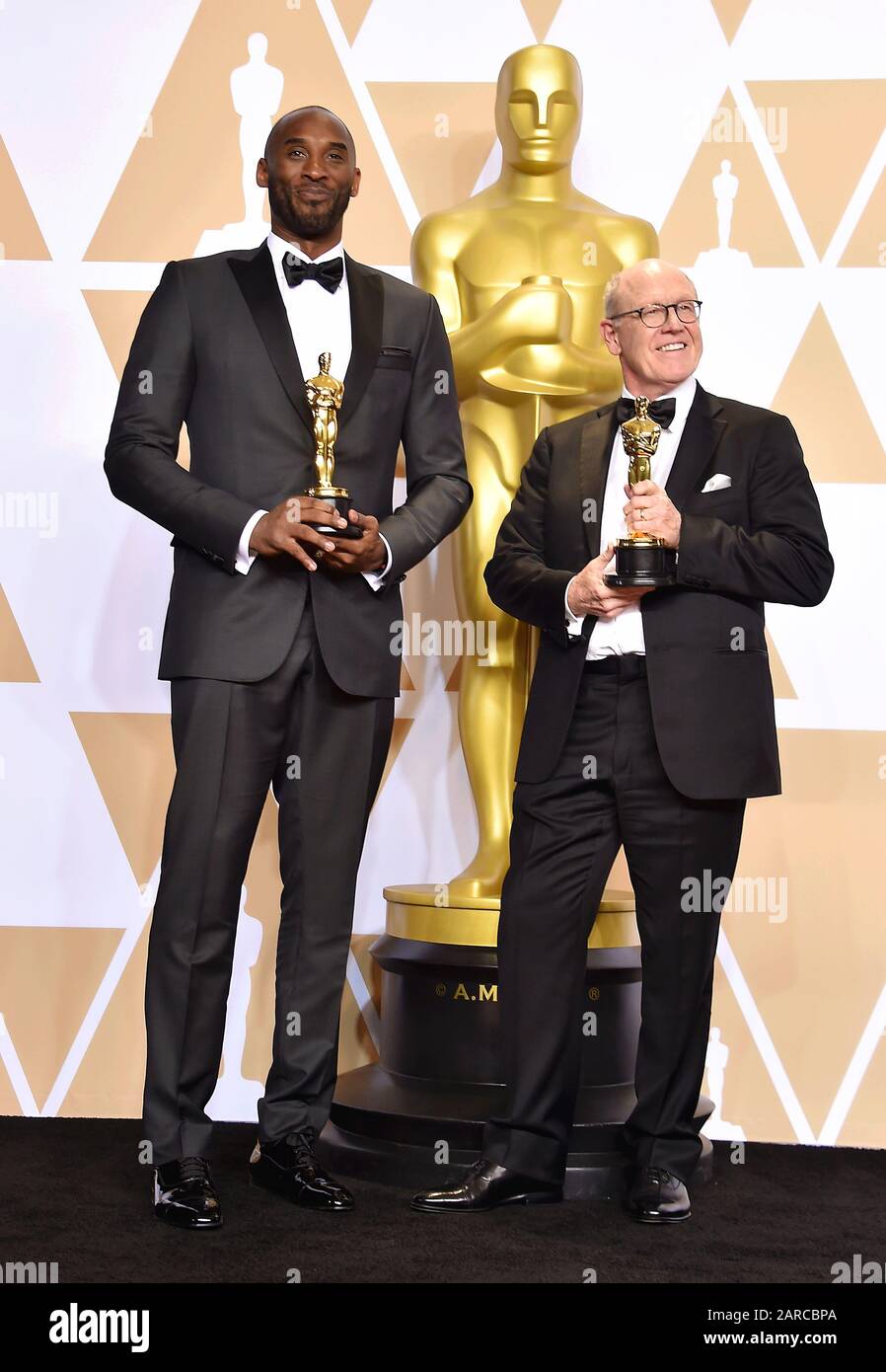 HOLLYWOOD, CA - MARCH 04: Filmmakers Kobe Bryant (L) and Glen Keane, winners of the Animated Short award for ?Dear Basketball? pose in the press room during the 90th Annual Academy Awards at Hollywood & Highland Center on March 4, 2018 in Hollywood, California. Stock Photo