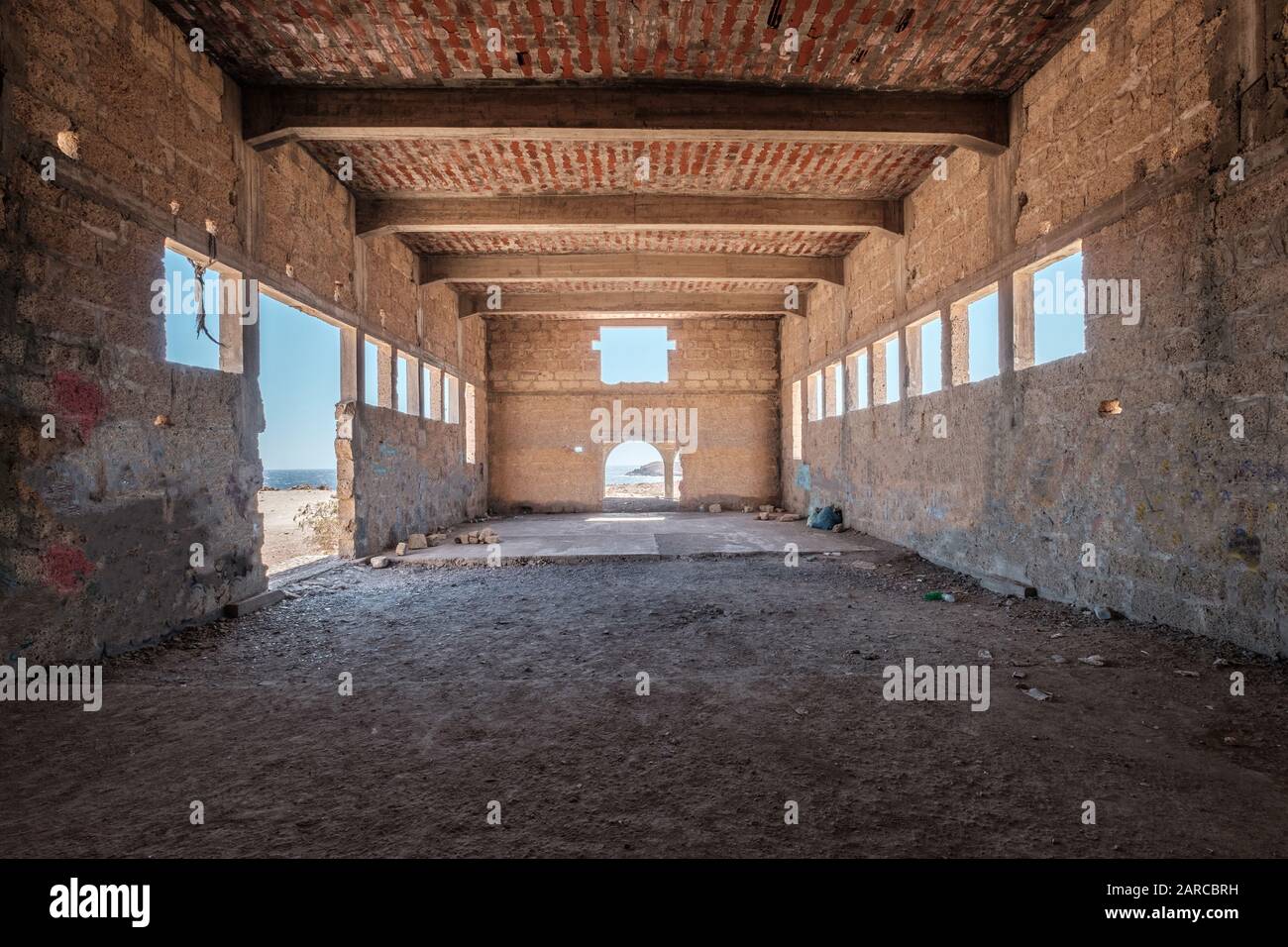 inside of abandoned warehouse or industrial ruin - run down building , empty space Stock Photo