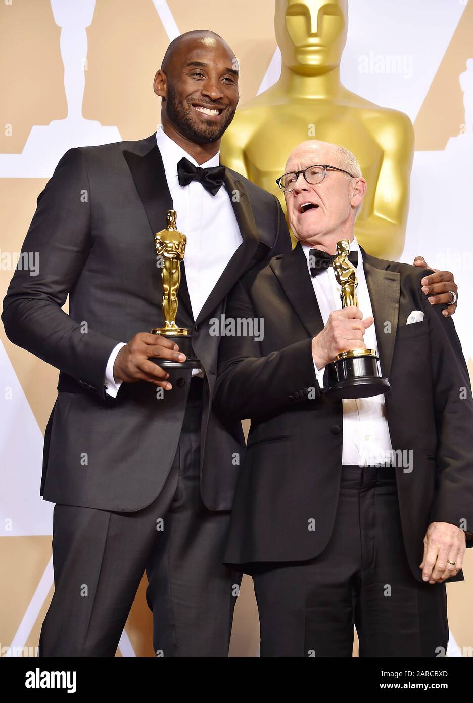 HOLLYWOOD, CA - MARCH 04: Filmmakers Kobe Bryant (L) and Glen Keane, winners of the Animated Short award for ?Dear Basketball? pose in the press room during the 90th Annual Academy Awards at Hollywood & Highland Center on March 4, 2018 in Hollywood, California. Stock Photo