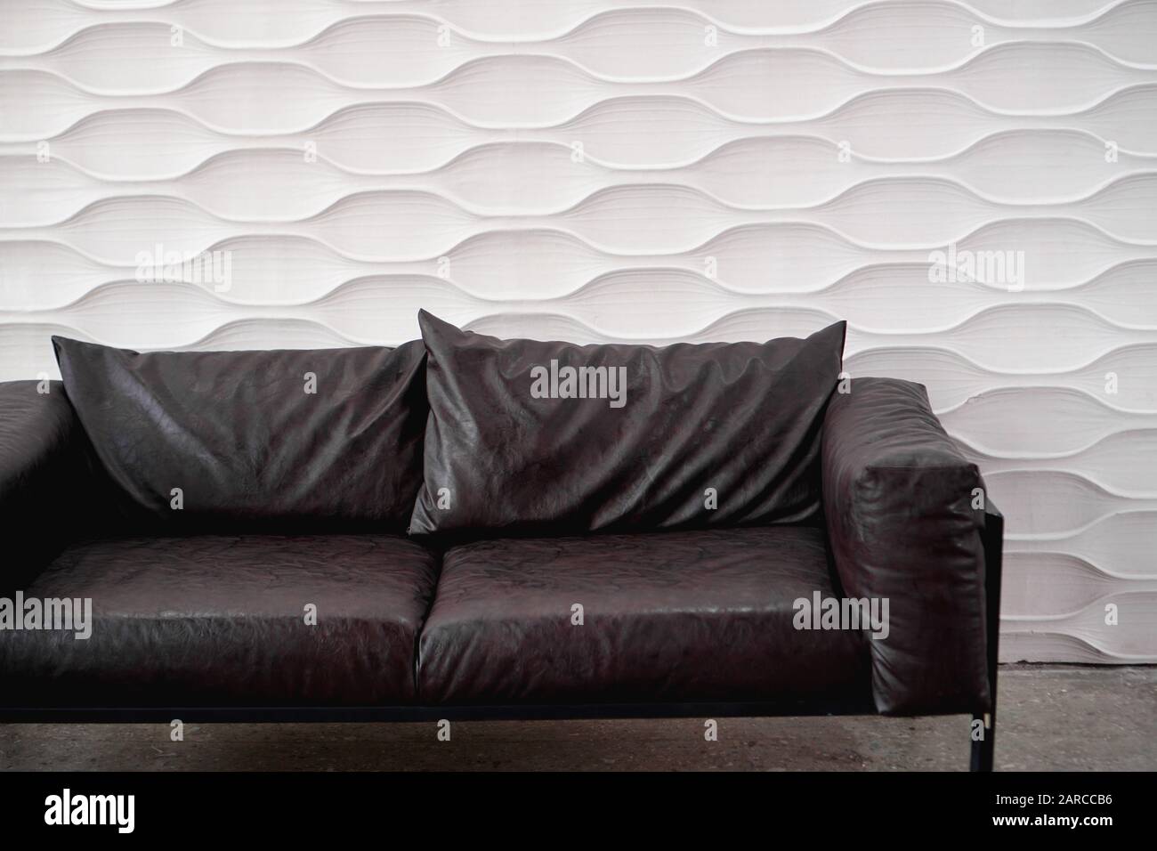 Black leather sofa on a white background in studio Stock Photo
