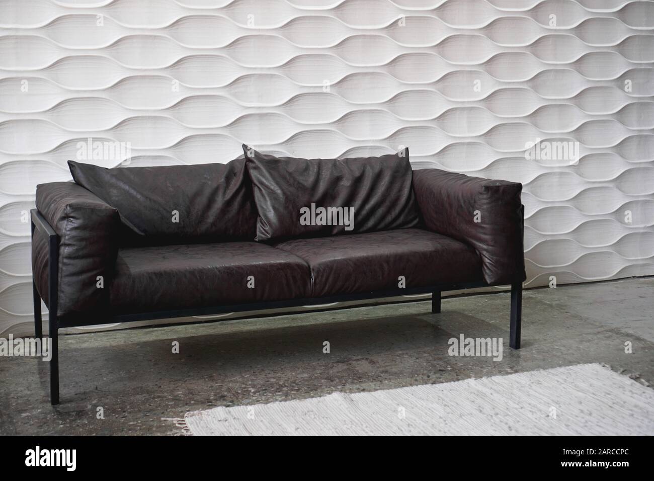 Black leather sofa on a white background in studio Stock Photo