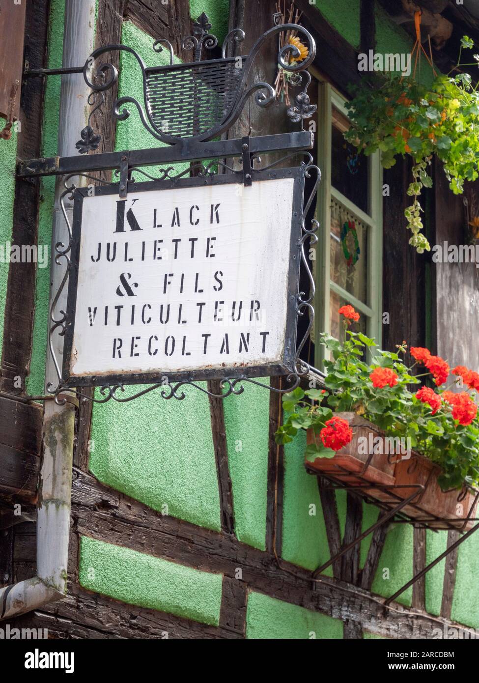 The traditional wrought iron sign at the Klack Juliette and sons viticulture and recoltant wine shop in Riquewihr  Alsace France Stock Photo