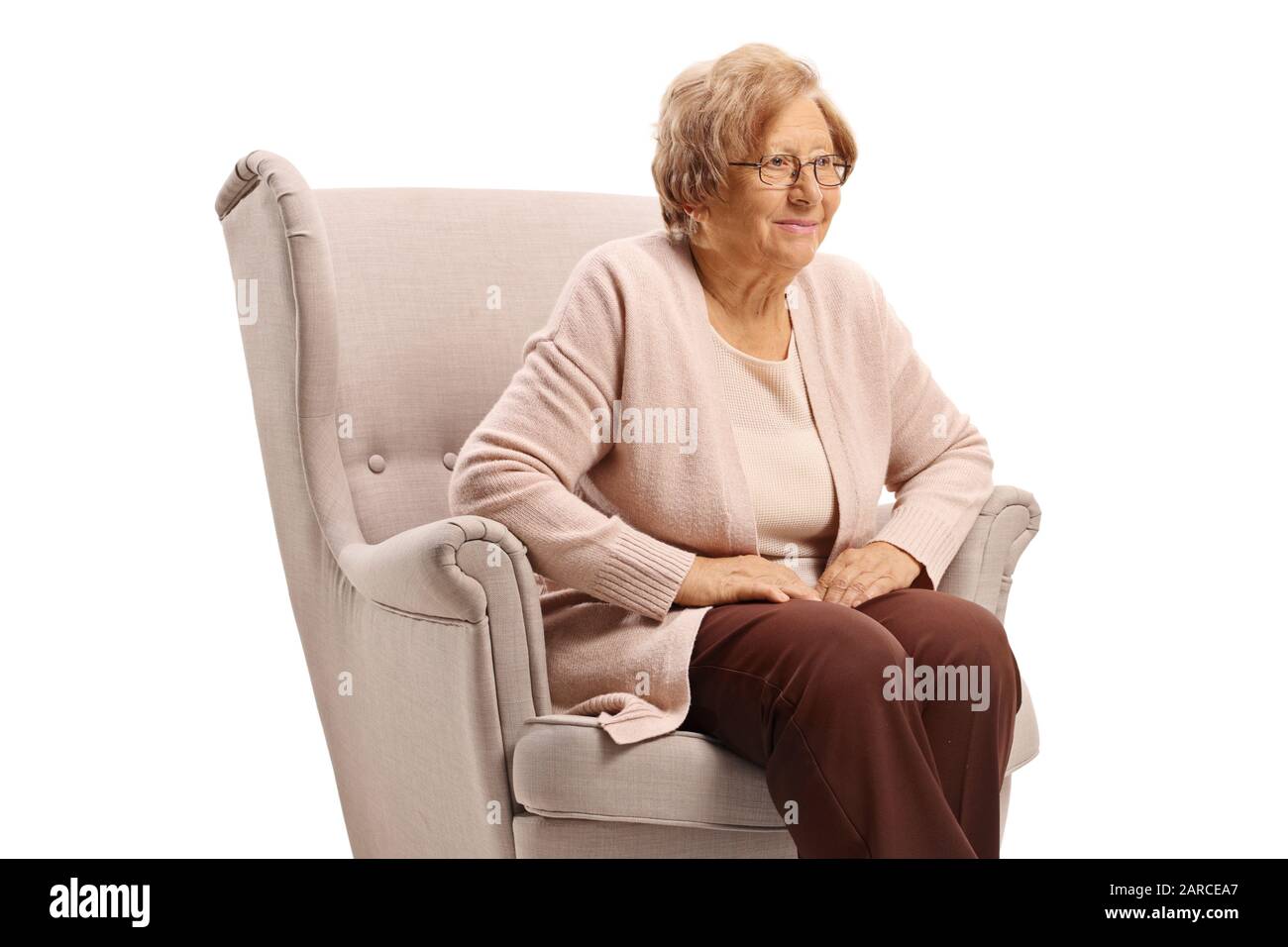 Elderly woman seated in comfy chair hires stock photography and images