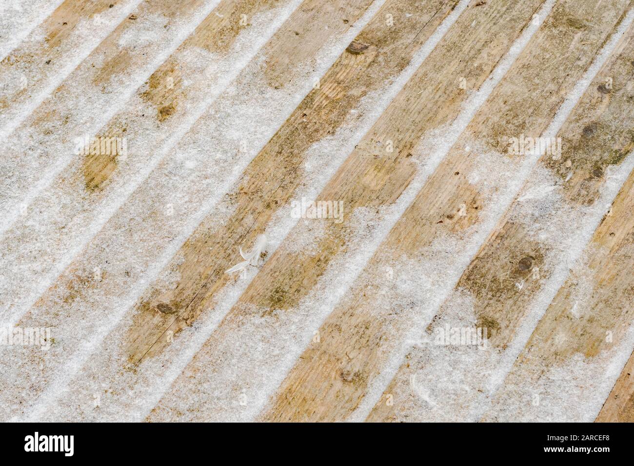 Snow covered wooden boards of a pallet awaiting recycling. Metaphor winter weather and chills, cold weather, seasonal cold weather, freezing cold. Stock Photo