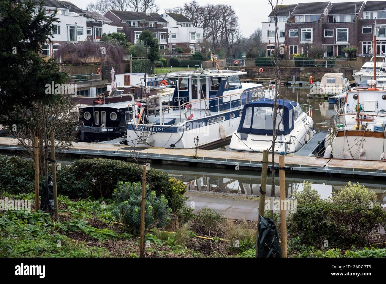 Boats moored on pontoons in yacht basin at Chiswick Key, on River