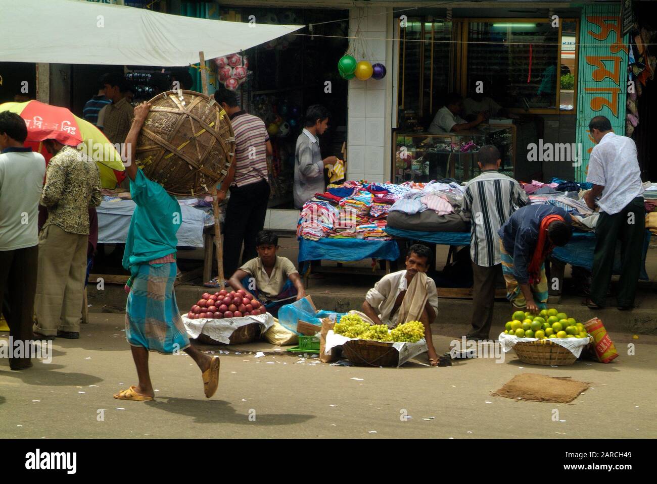 Dhaka, Bangladesh - September 17, 2007: Unidentified people and street vendors on traditional market Stock Photo