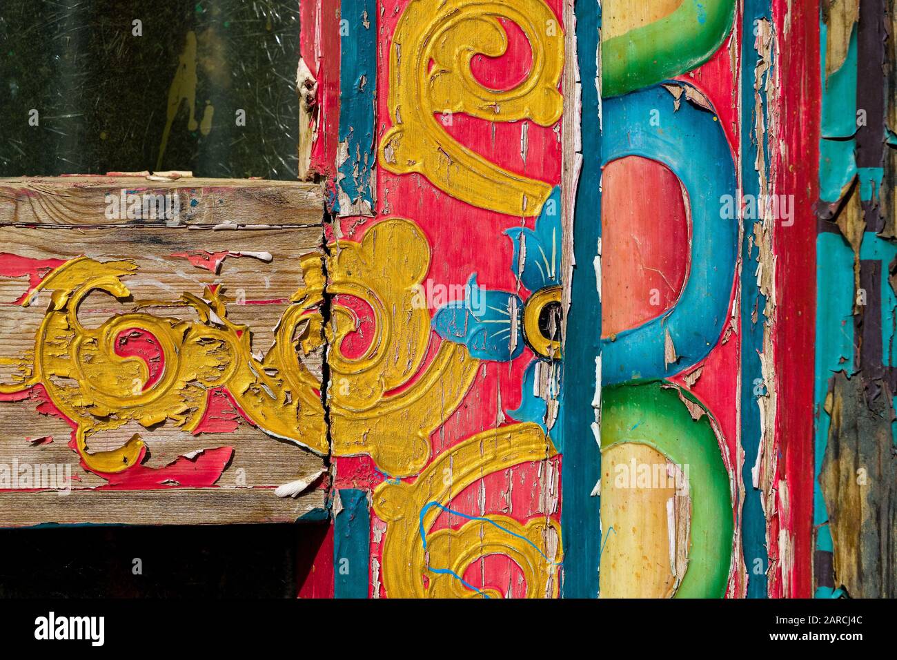 Brightly coloured but fading decorative painting on door of a Buddhist monastery, Nepal Stock Photo