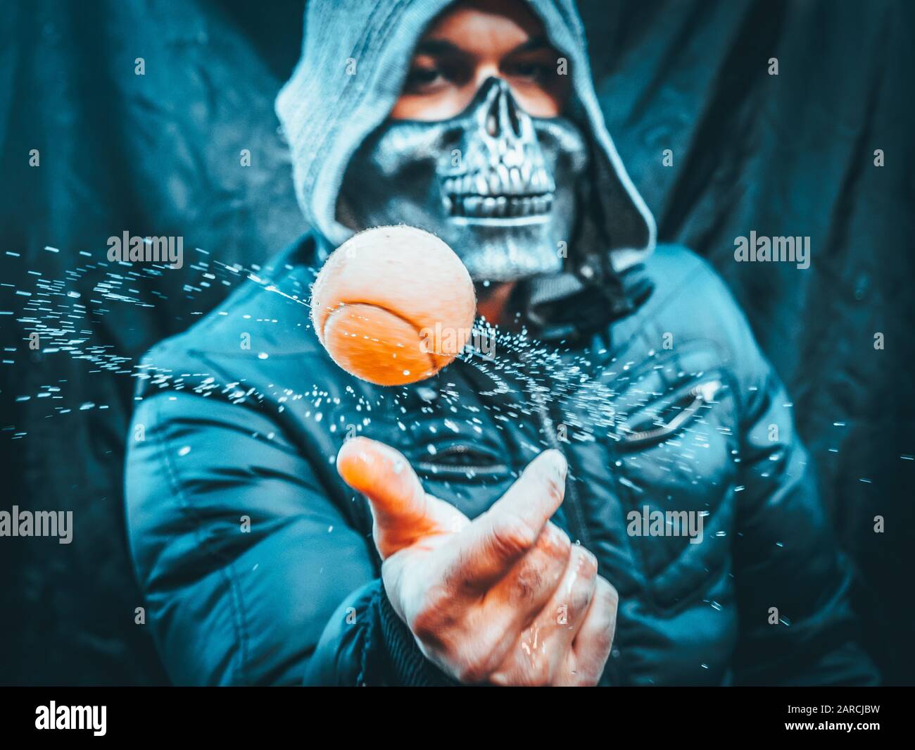 Creative shoot of a skull man with a tennis ball Stock Photo