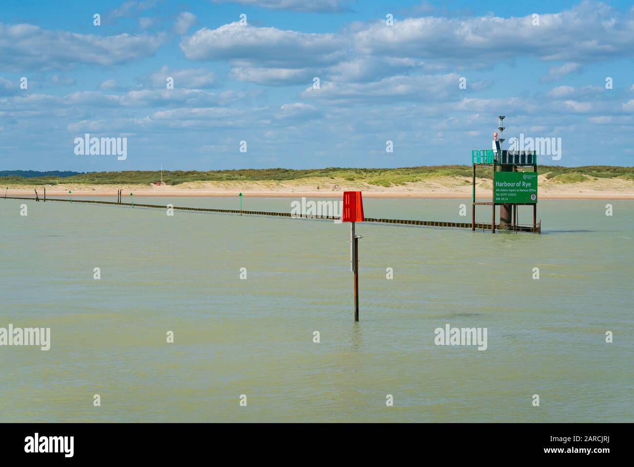 Rye Harbour - August 20 2019; Navigation marker and sign at entrance to Rye Harbour on Rother River. Stock Photo