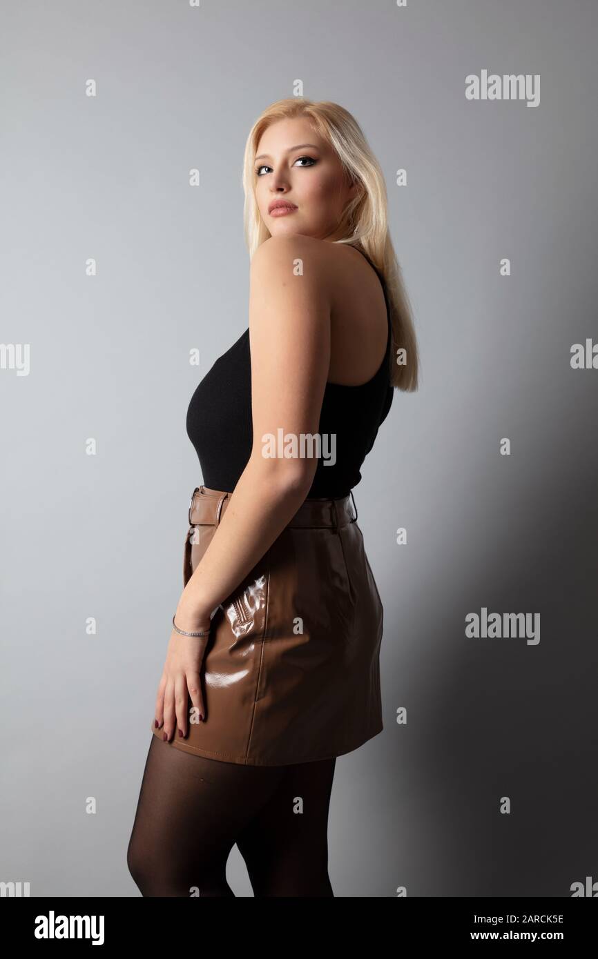 a beautiful Italian sexy curvy tall blonde model, studio shot
