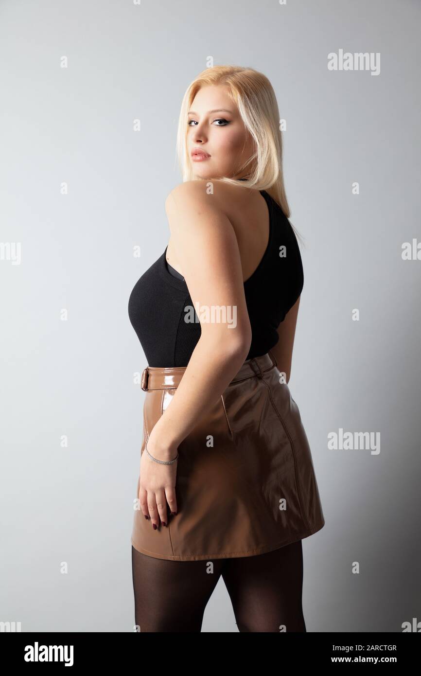 a beautiful Italian sexy curvy tall blonde model, studio shot