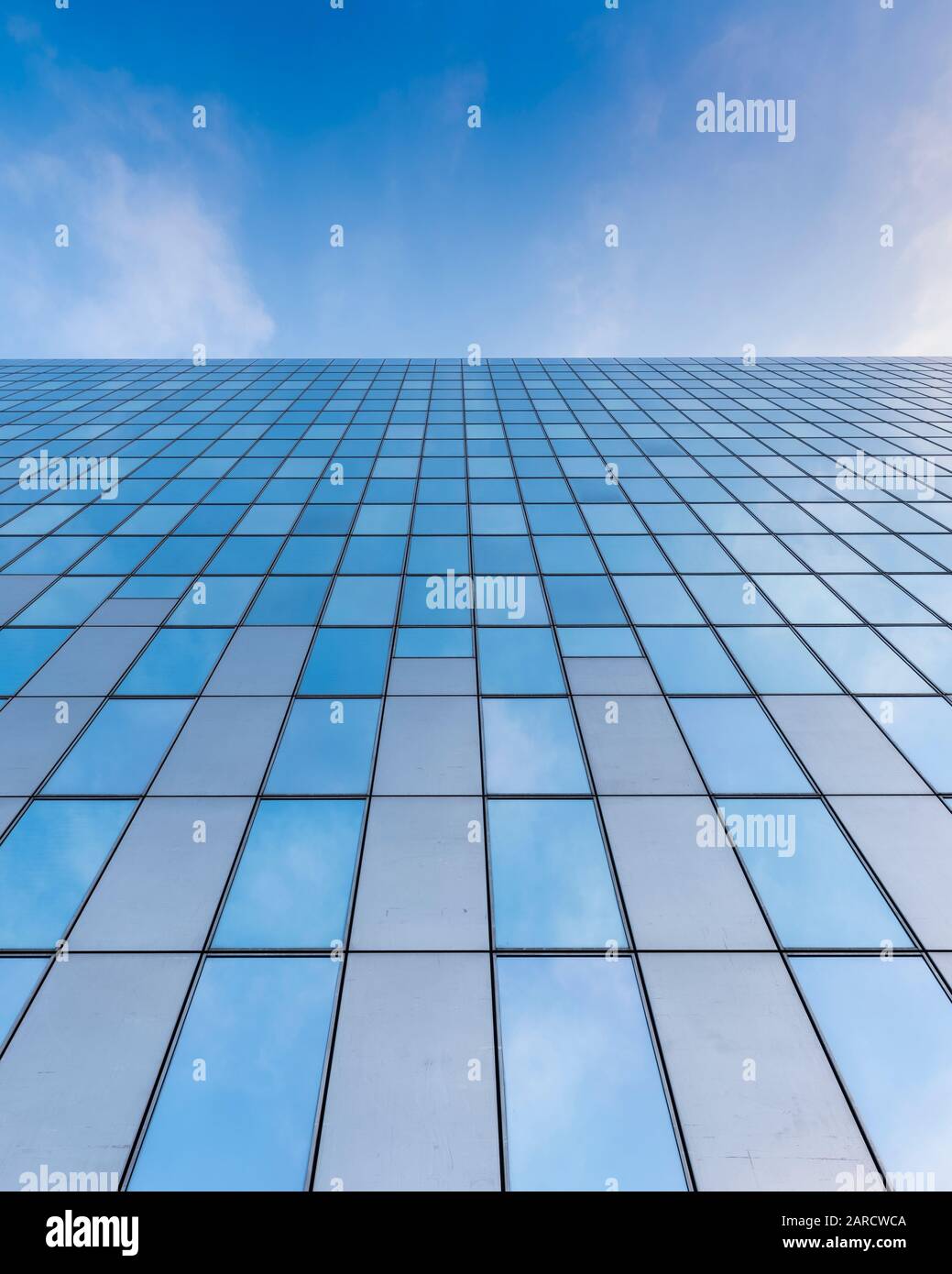 glass facades of modern office buildings and reflection of blue sky ...