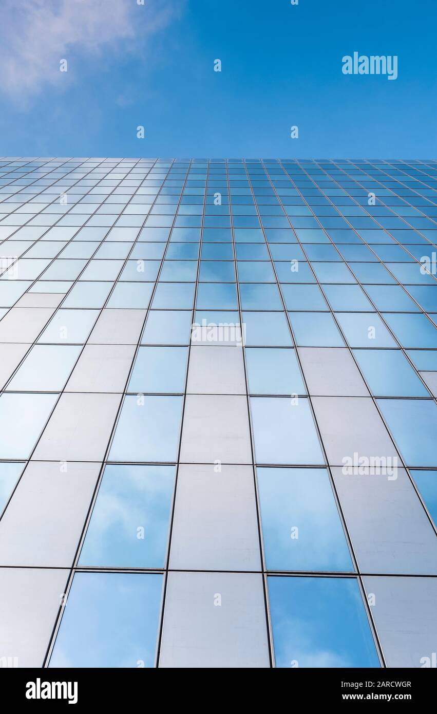 glass facades of modern office buildings and reflection of blue sky ...
