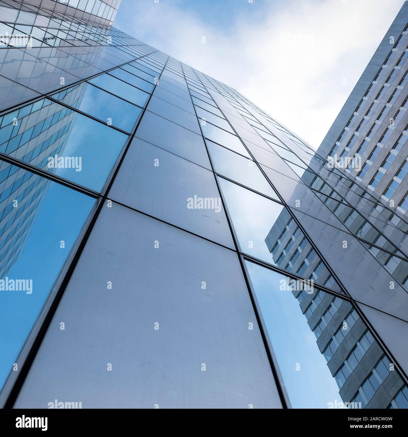 glass facades of modern office buildings and reflection of blue sky ...