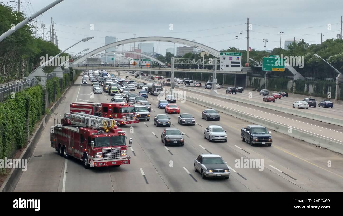 Two fire trucks respond to a crash on Interstate 69 (Highway 59) in Houston, Texas. Two lanes are closed to make way for emergency vehicles. Stock Photo