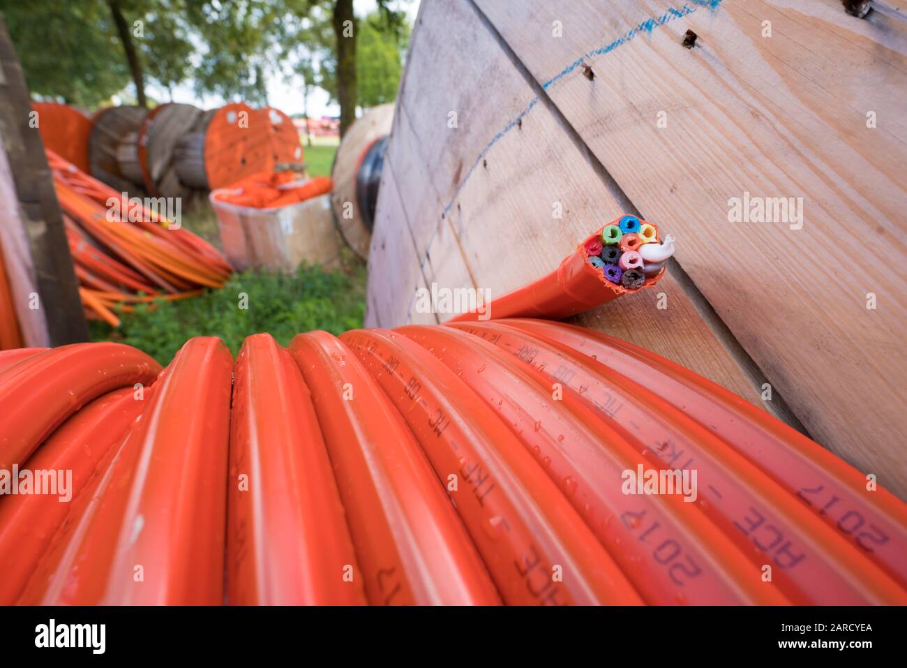 HENGELO, NETHERLANDS - AUGUST 25, 2018: closeup of a cable drum with orange fiber glass cable on a construction site Stock Photo