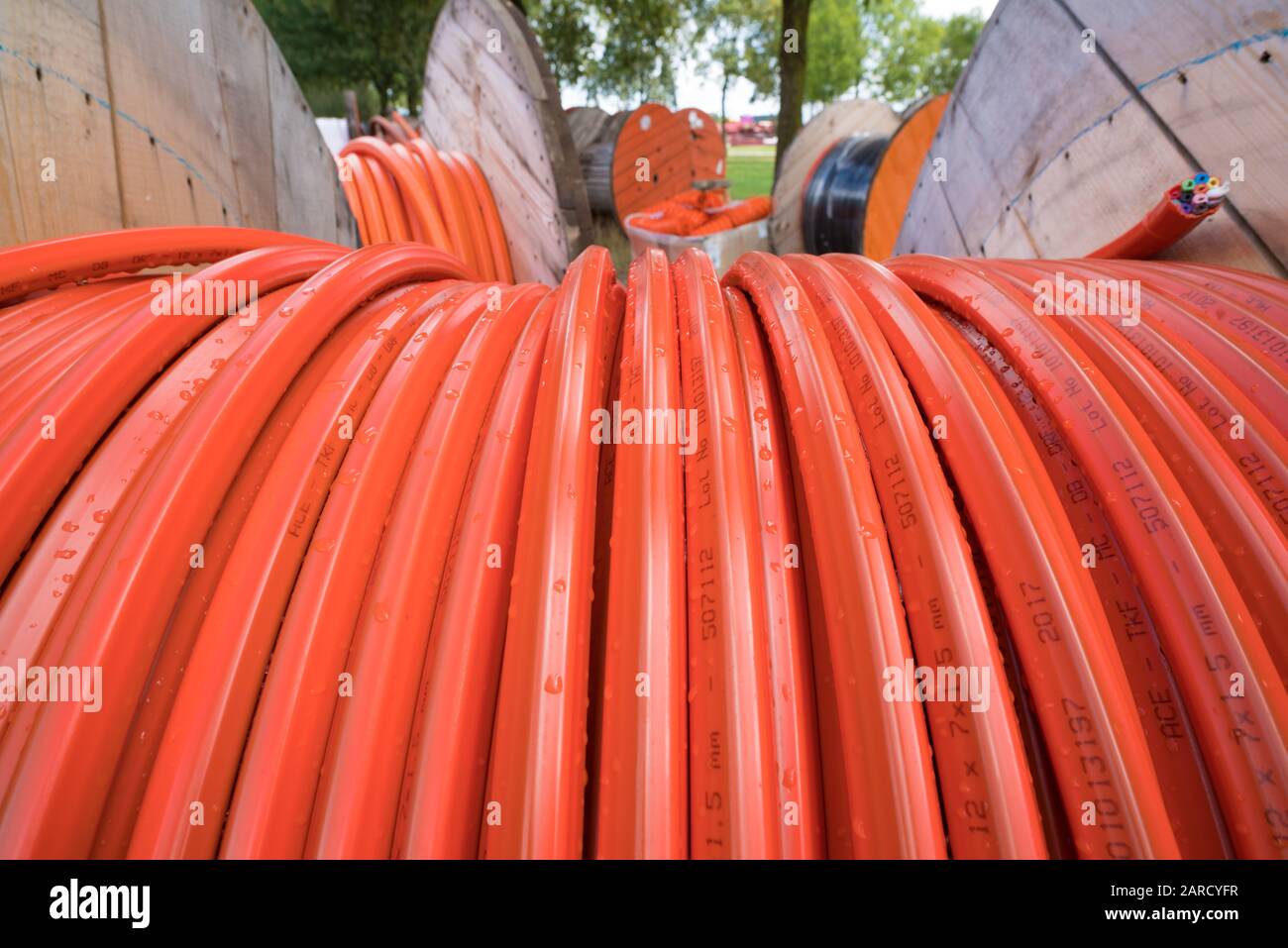 HENGELO, NETHERLANDS - AUGUST 25, 2018: closeup of a cable drum with orange fiber glass cable on a construction site Stock Photo