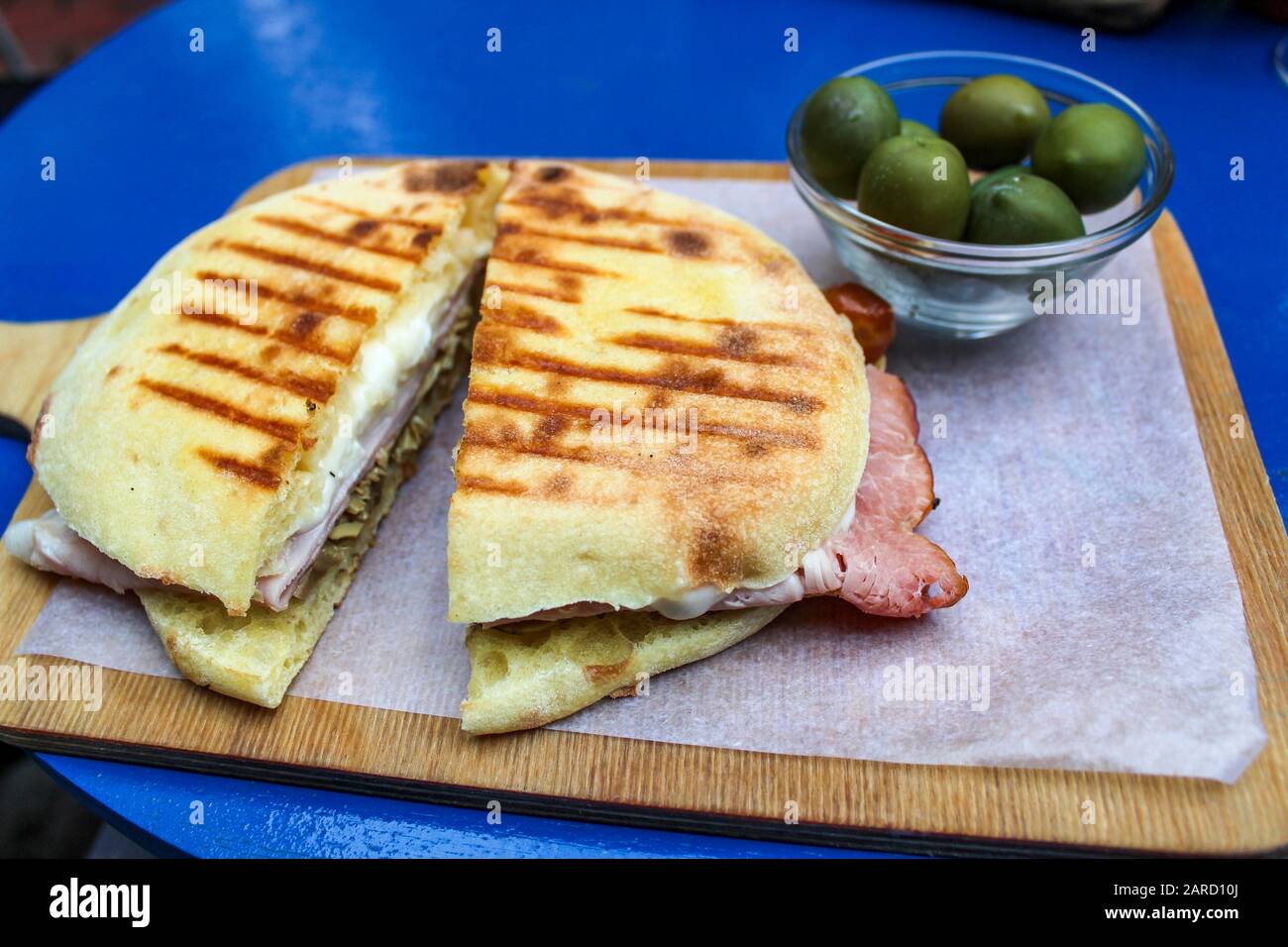 Italian panino on wooden board with olives Stock Photo