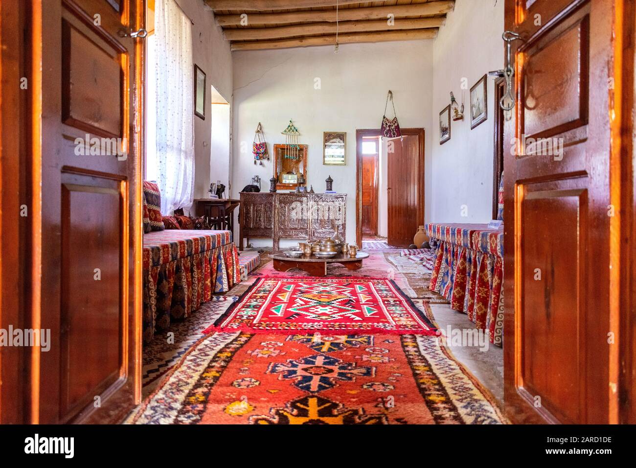 Traditional Turkish house interior with all authentic furniture and carpets  on the floor. Light coming in through the side window Stock Photo - Alamy