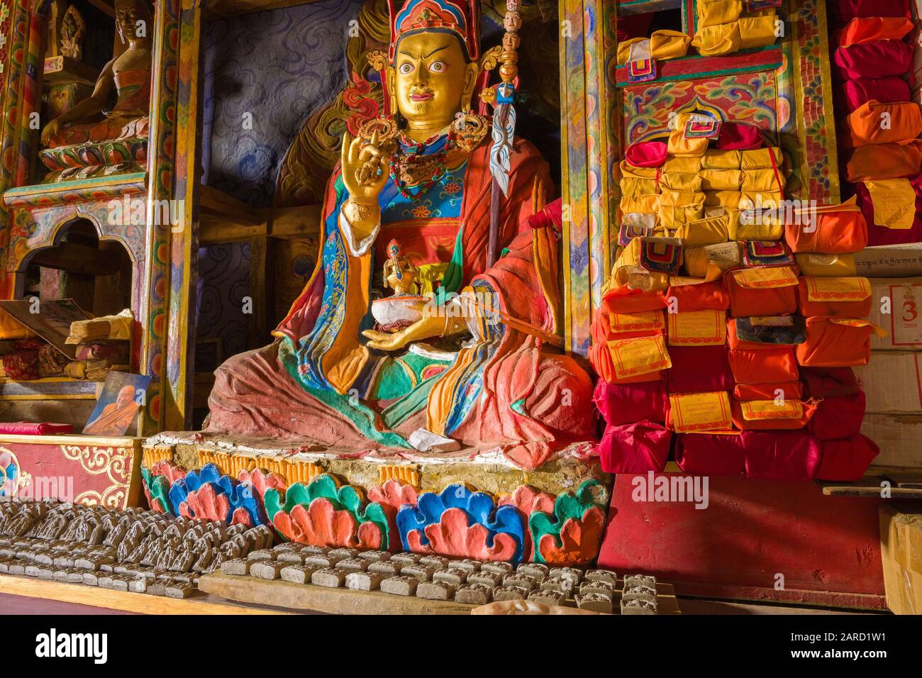 Buddhist texts and statue in a Tibetan Monastery / Gompa, Dolpo,Nepal Stock Photo