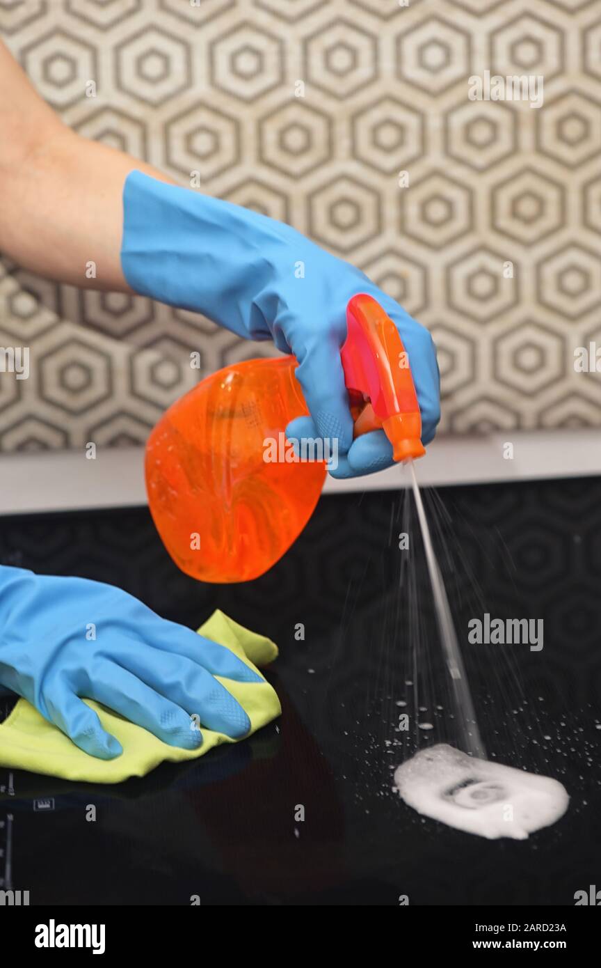 Woman Hands Cleaning A Modern Black Induction Hob Stock Photo