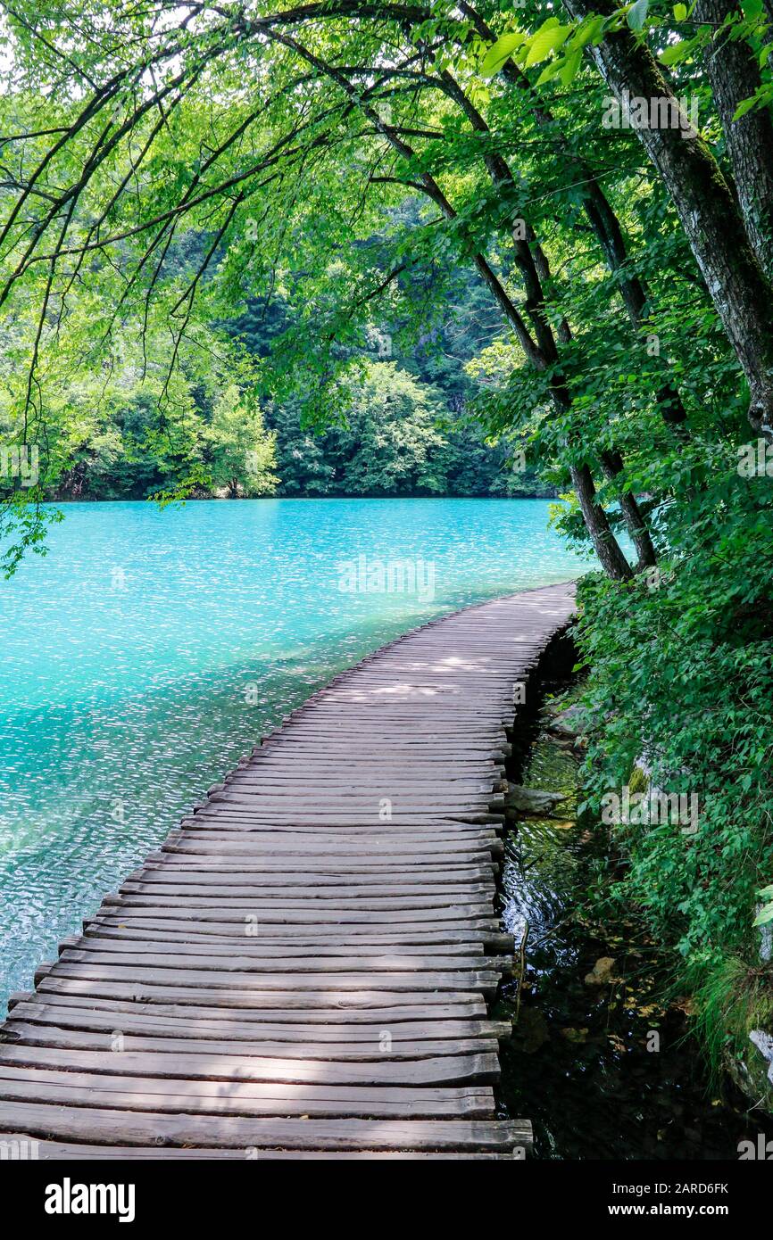 Wooden walkways beside the turquoise waters in Plitvice Lakes National Park in Croatia Stock Photo