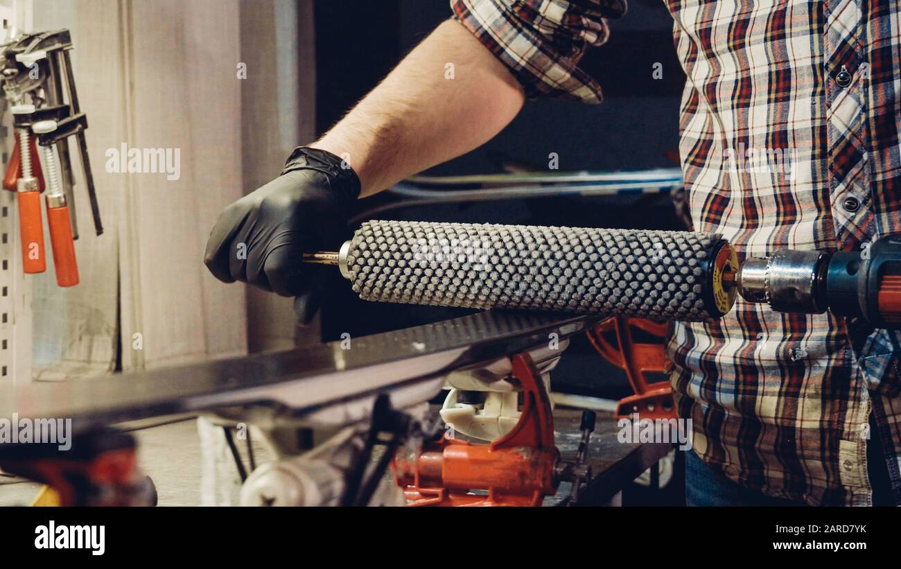 Base polishing, final ski polishing. In hands electric brush rotor