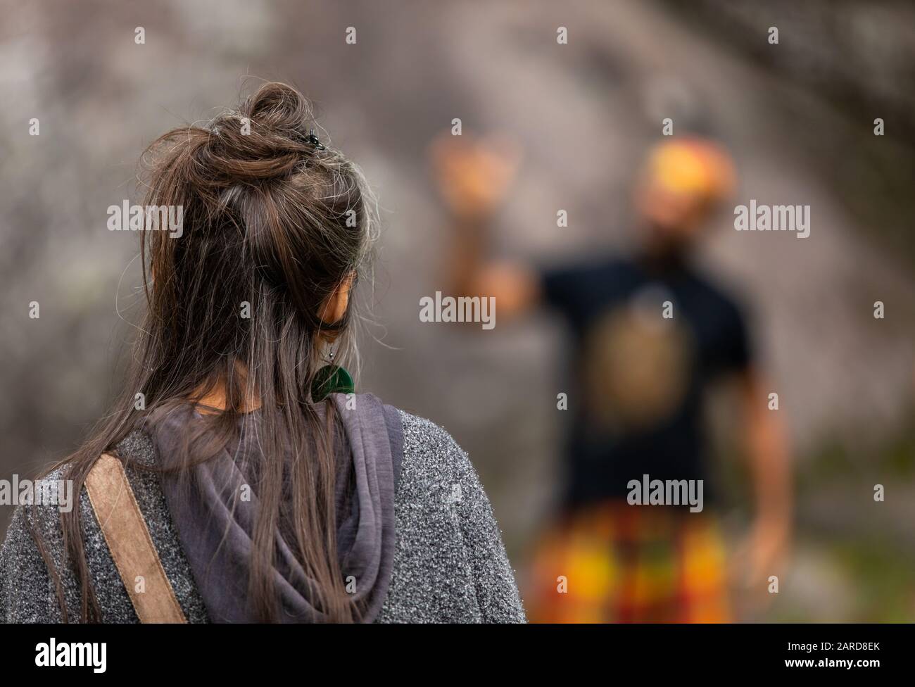 Closeup Rear View Of Female With Messy Black Hair Wearing Hoodie