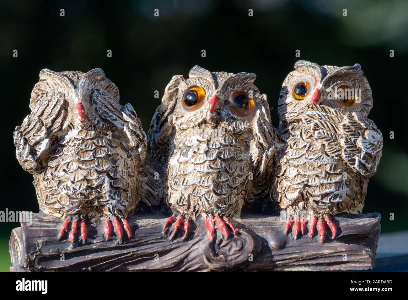 Close up of an ornament of three owls depicting the proverb see no evil