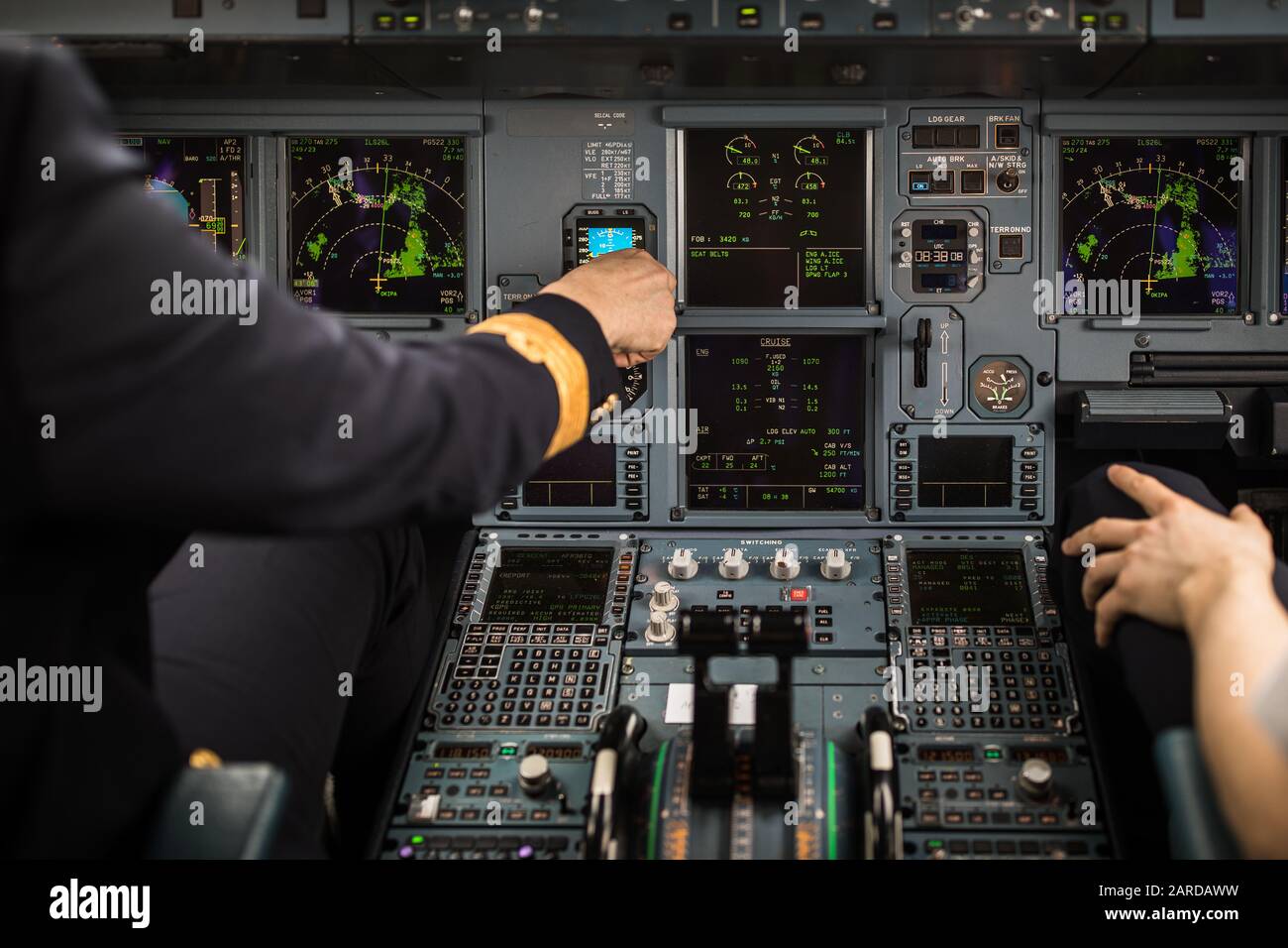 Pilot's hand accelerating on the throttle in a commercial airliner ...