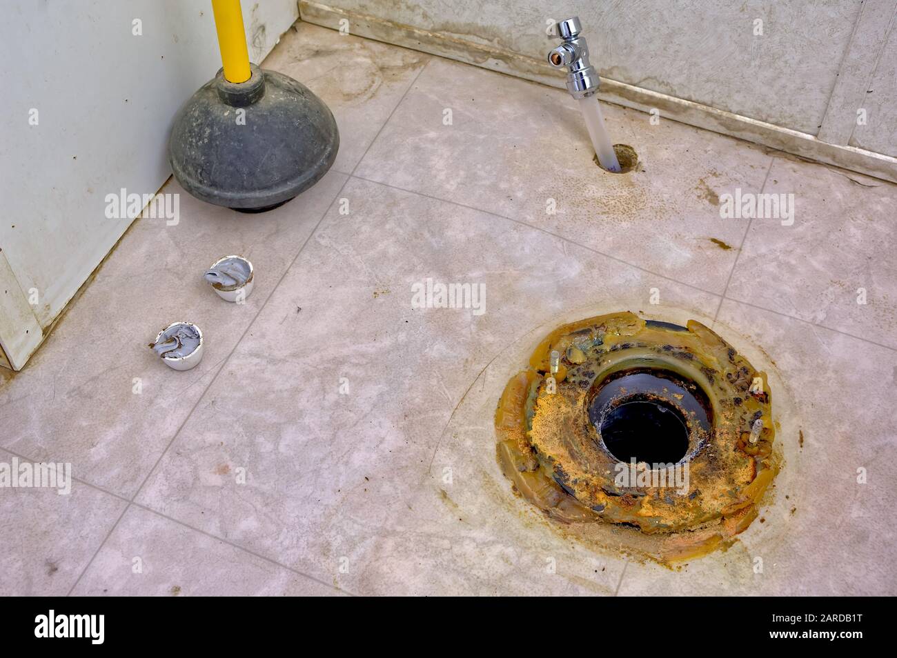 The melted remains of a wax ring seal that is beneath most toilet bowls. In this case the toilet bowl was removed to inspect for flood damage after th Stock Photo
