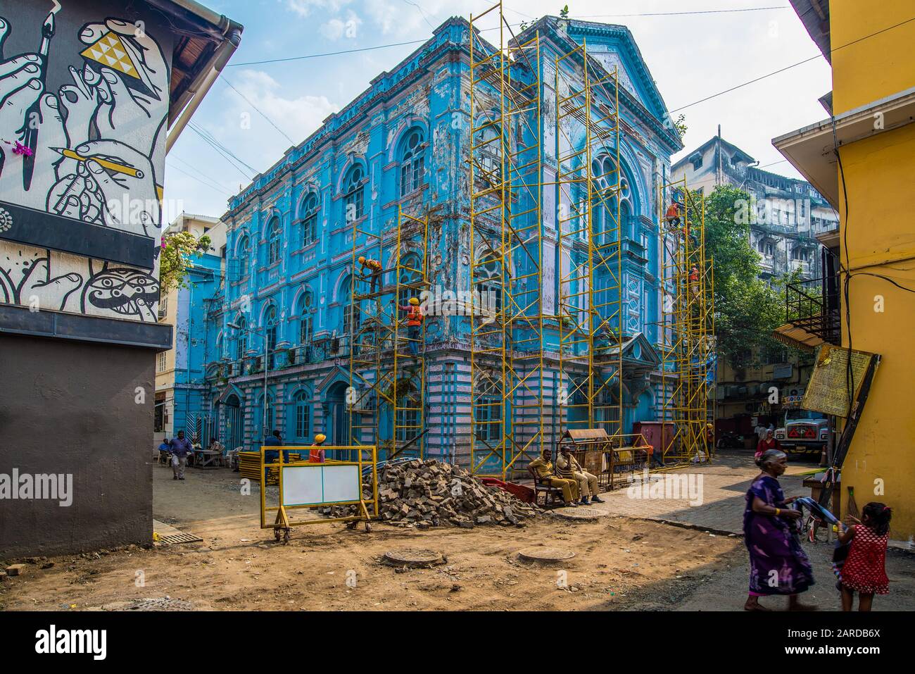 Mumbai, India - December 15, 2017: A blue synagogue being renovated with scaffoldings with some passersby. Stock Photo