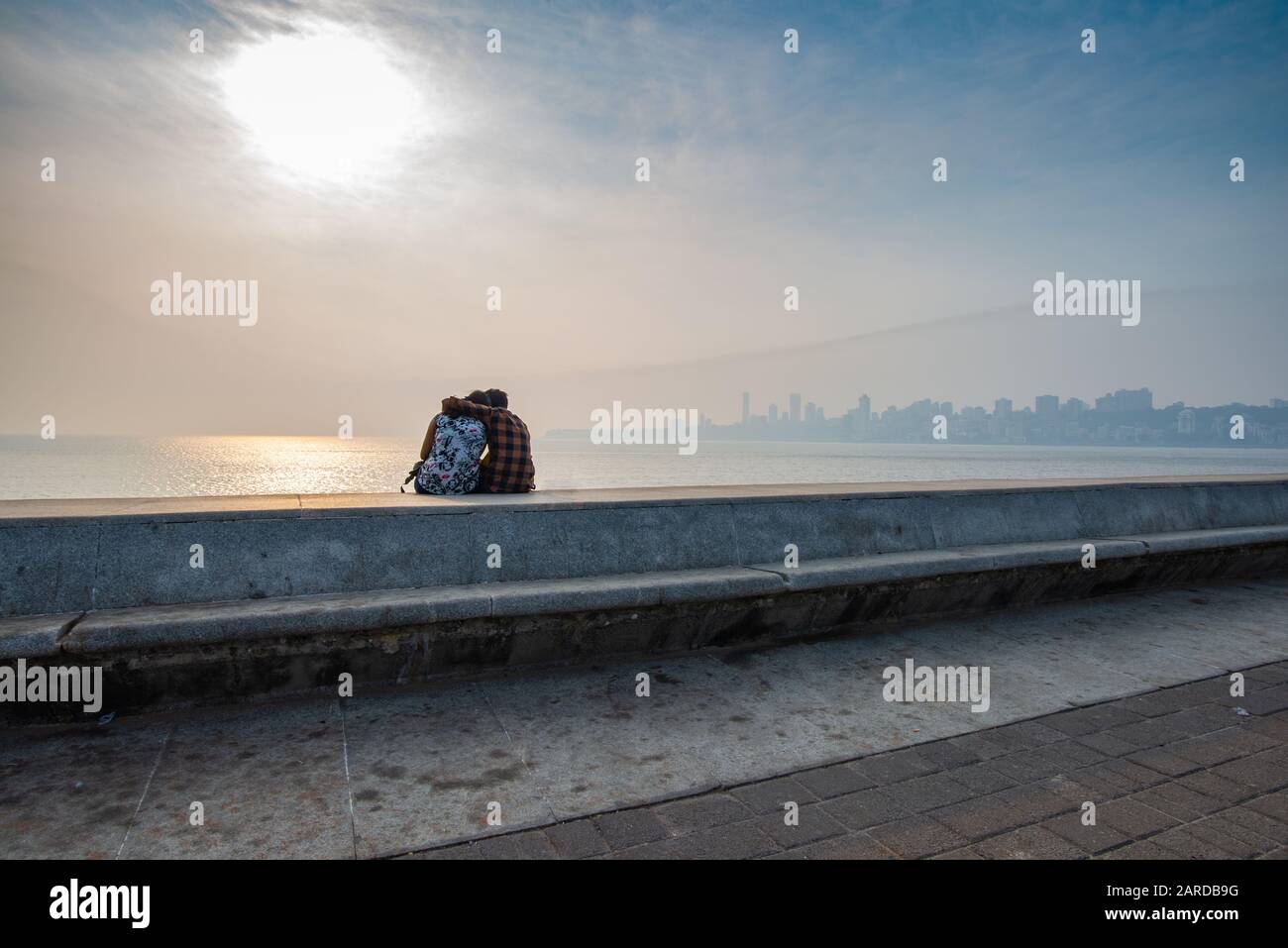 Unrecognisable lovers on Marine Drive, taken at the end of the afternoon, Mumbai, India Stock Photo