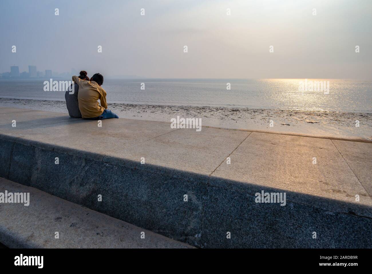 Unrecognisable lovers on Marine Drive, taken at the end of the afternoon, Mumbai, India Stock Photo
