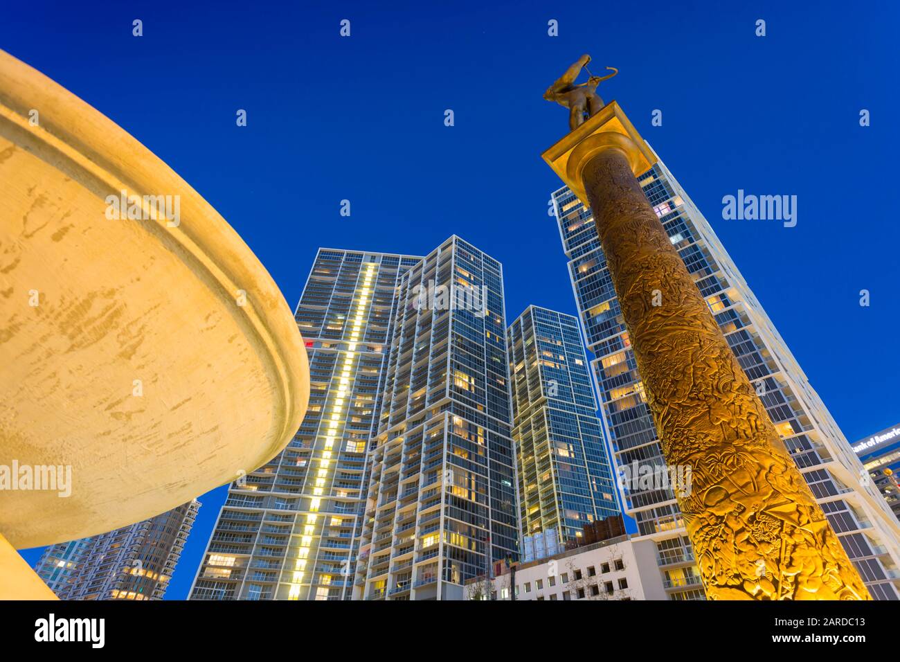 City skyscrapers and monument on Brickell Avenue at dusk in Downtown Miami, Miami, Florida, United States of America, North America Stock Photo