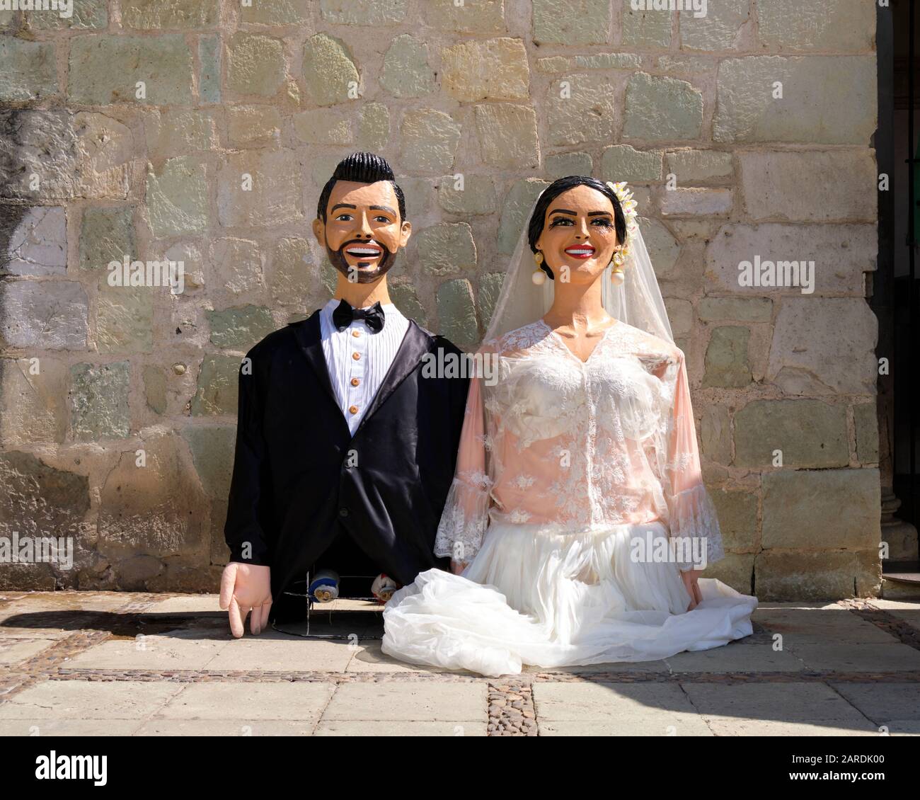 Giant puppets depicting the bride and groom prior to start of Traditional wedding parade (Calenda de Bodas) on the streets of Oaxaca. Stock Photo