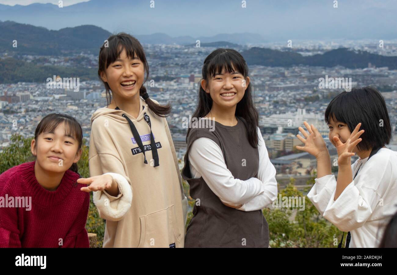 Japanese teenagers posing for photograph, Arashiyama, Kyoto, Japan Stock Photo