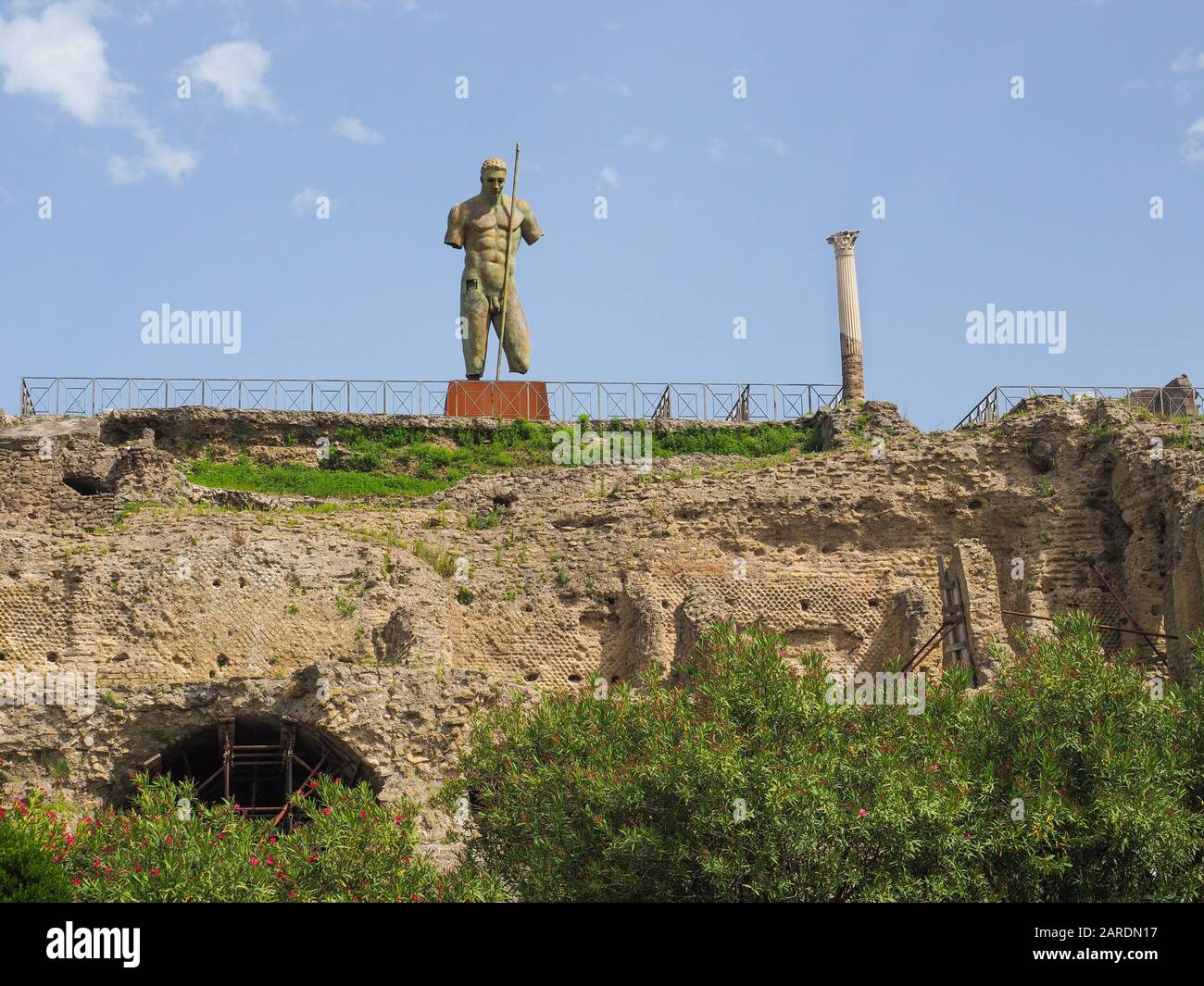 Igor Mitoraj's bronze man's classic sculpture over the ruins of Pompeii. Archaeological Area located near the modern town of Pompei and Mount Vesuvius Stock Photo