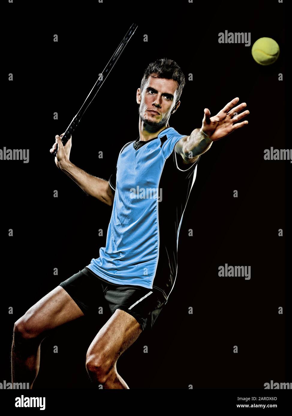 one caucasian young player tennis man in studio isolated on black background Stock Photo