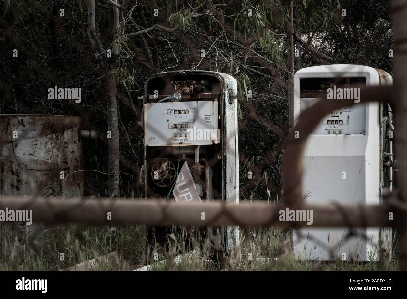 Padlocked gate to disused fuel bowsers on abandoned resort. Great Keppel Island, Queensland Stock Photo