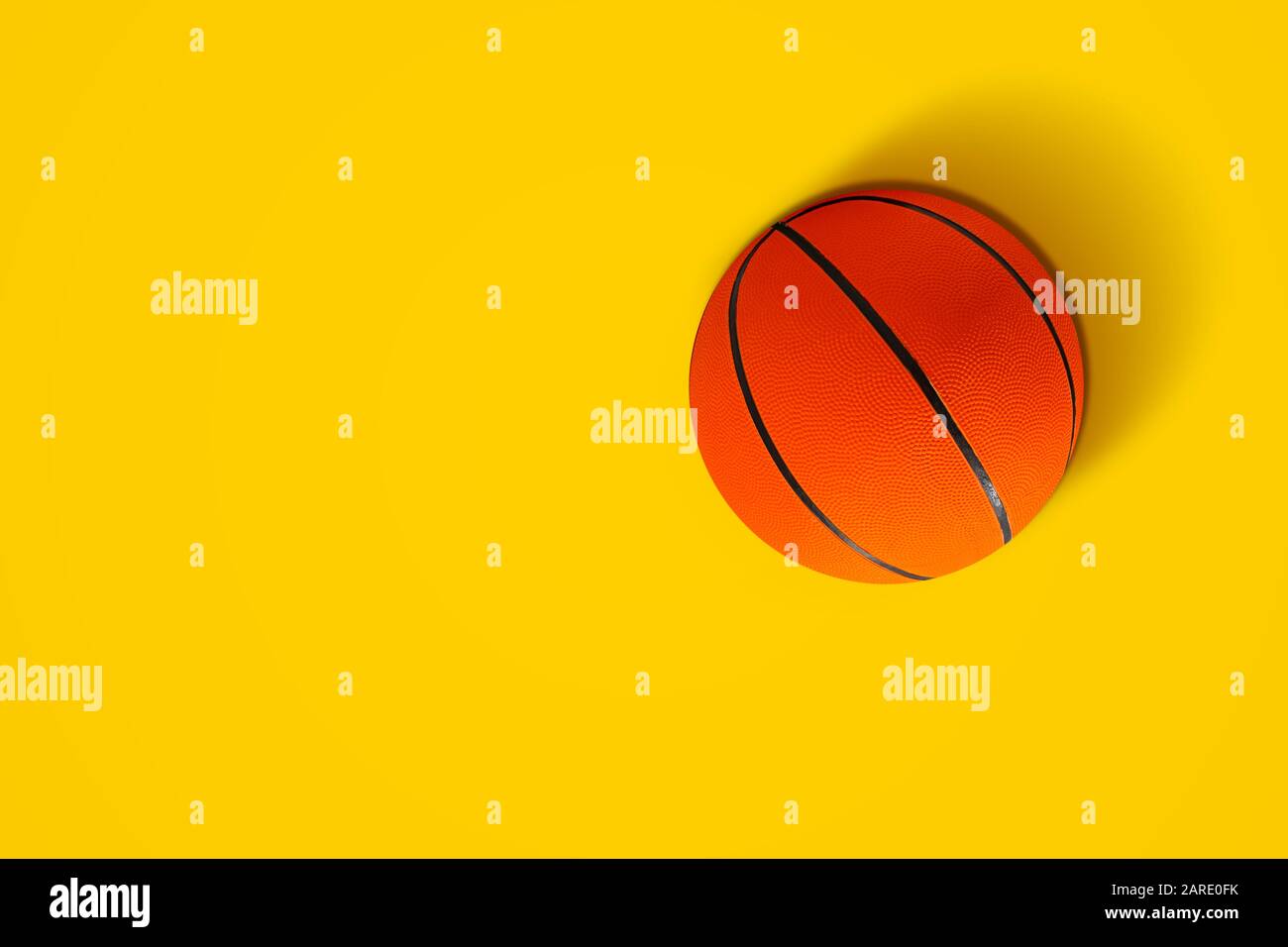 Basketball in vibrant color on yellow background Stock Photo Alamy