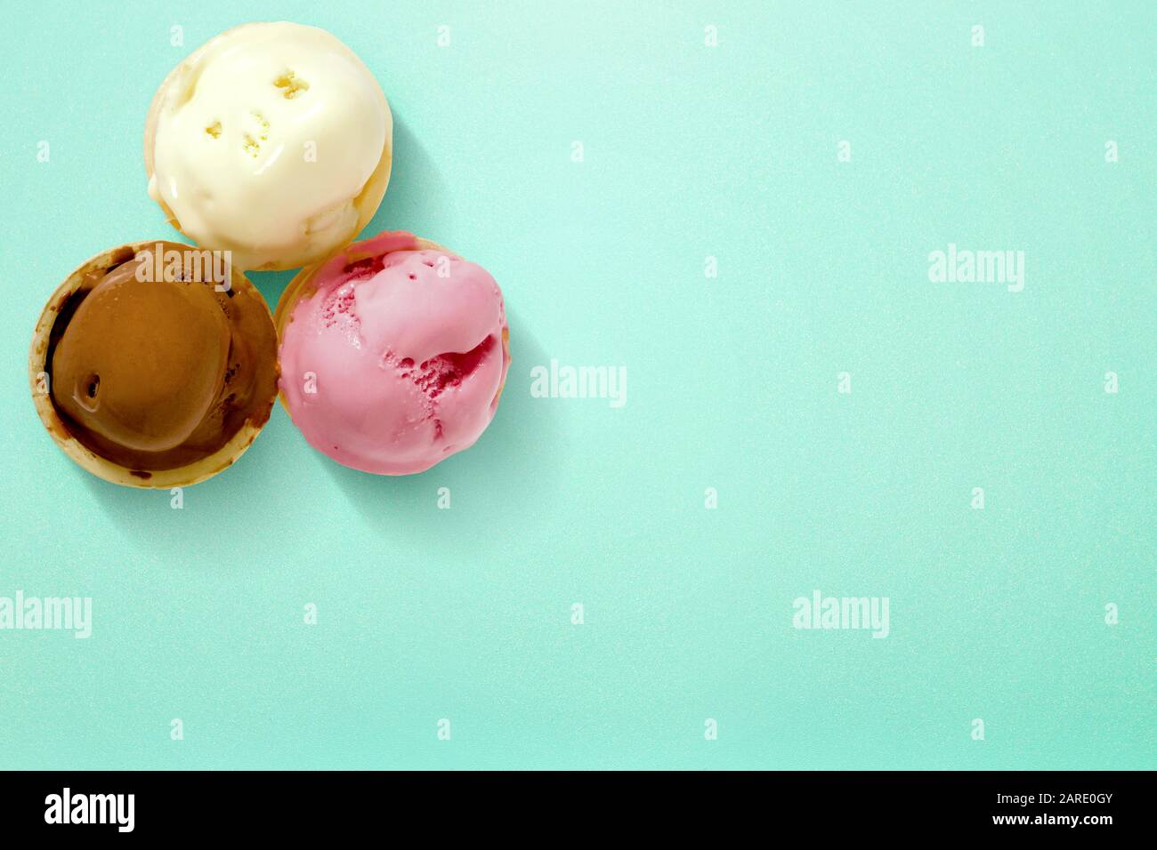 Ice cream cone in vibrant color on a green background Stock Photo - Alamy