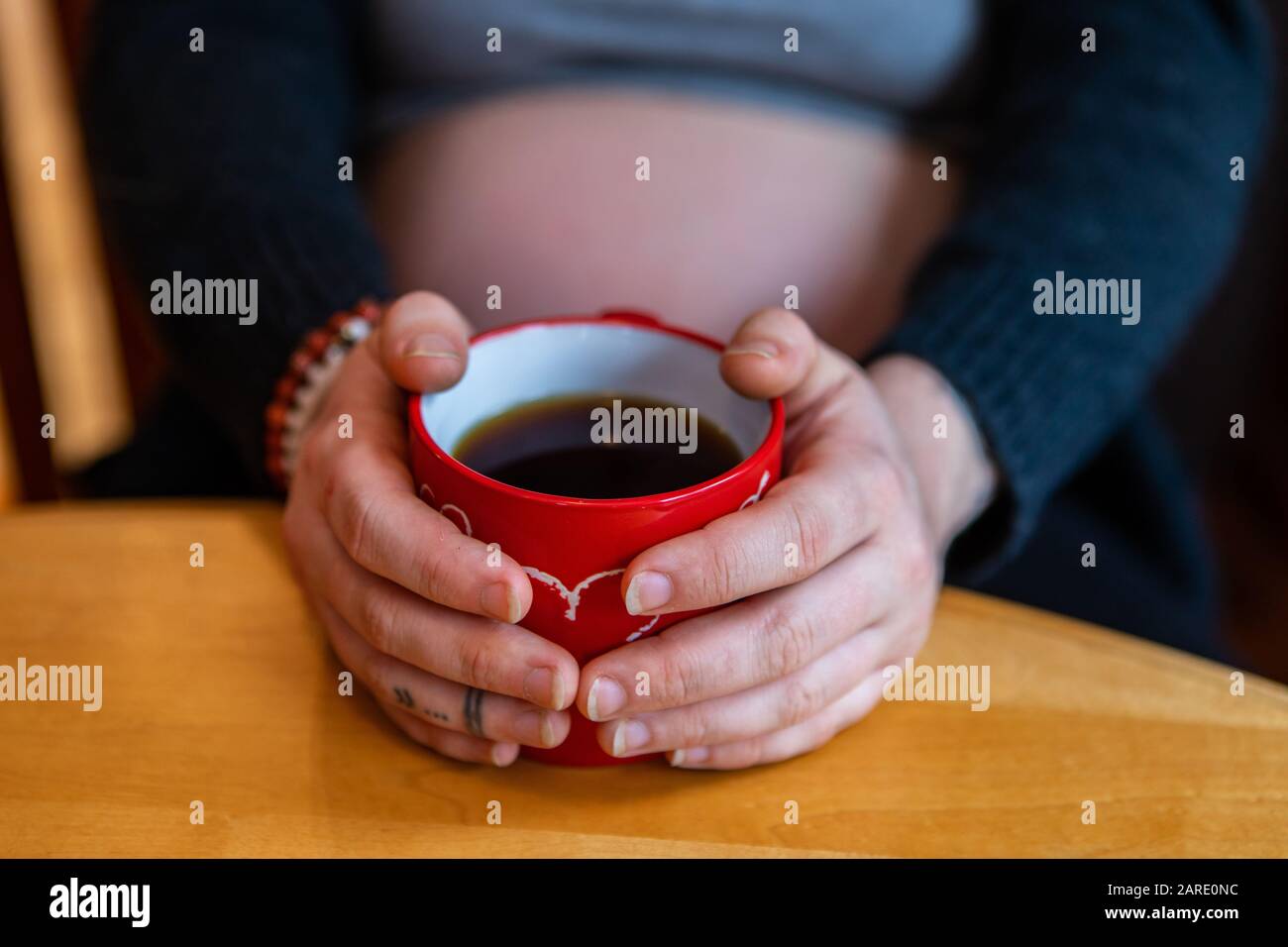 A creative selective focus view of a woman in later stages of pregnancy