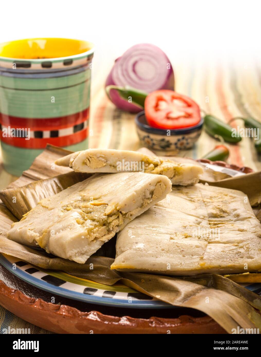 Tamales Oaxaqueños, Mexican dish made with corn dough, chicken or pork and chili, wrapped in a banana leaves. Stock Photo