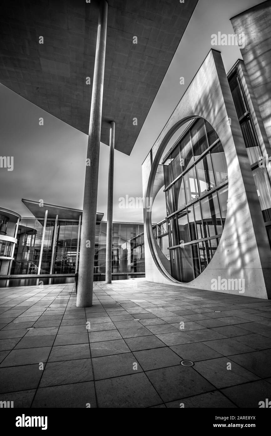 Vertical grayscale shot of modern buildings under a cloudy sky Stock ...
